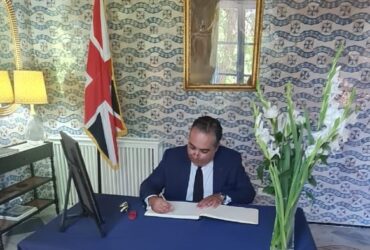 The TBCC President writing in the condolences book